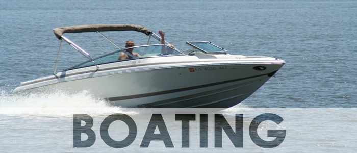 Image of two people riding in their boat creating a wake