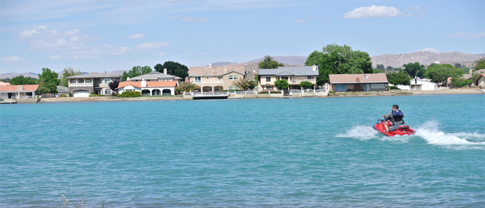 Image of a person riding a jet ski on the lake