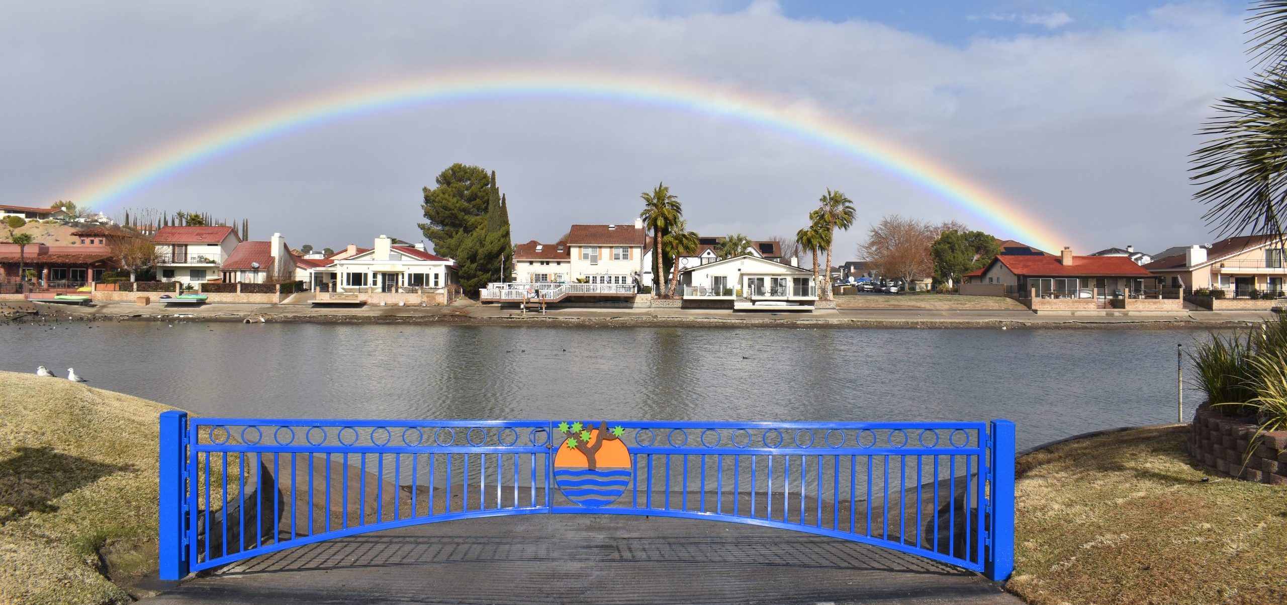 Boat ramp gate with a rainbow in the background